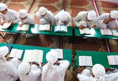 Students recite the holy Koran to illustrate Taliban begins religious reform of Afghan universities