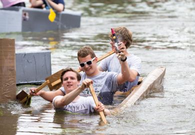 Cambridge University students  on the River Cam taking part in Suicide Sunday cardboard boat race to illustrate Will Labour commit to a graduate tax in England?