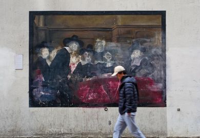 Person walking past a damaged painting in Amsterdam