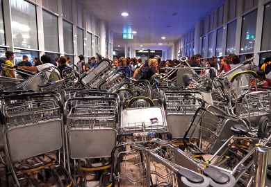  Barricades are seen at Barcelona Airport as people take part in a protest to illustrate Spanish criticise entrance exam ‘barrier’ for overseas students