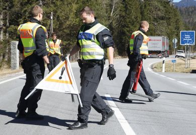 German police guards secure an access road German police guards secure an access road to illustrate Language barrier holds back international academics in Germany