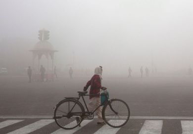 A cyclist amidst morning smog in New Delhi to illustrate ‘Deeper malaise’ threatens future of pan-Asian university