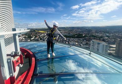 A visitor to British Airways i360 Viewing Tower in Brighton standing on the skywalk A visitor to British Airways i360 Viewing Tower in Brighton standing on the skywalk to illustrate TPS: universities seek respite from £125 million pensions bill