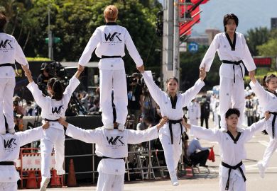 A group of youngTaiwanese from a martial art organization show their skills to illustrate Taiwanese ‘merger’ seen as a model for struggling universities