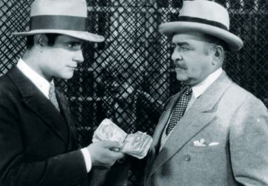 Victor Varconi (1896-1976) handing money to the lawyer in a scene from the film 'Chicago' as a metaphor for Sheffield ‘turned down £10 milllion’ for apprenticeships