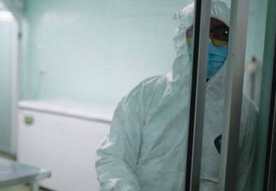  A health worker closes  the door of a laboratory as a metaphor for Many postdoctoral researchers in the UK are suffering in silence because they feel unable to report discriminatory microaggressions