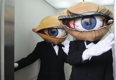 Performers wearing a large eyeball in a lift in Yokohama