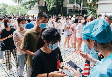 Students queue up for nucleic acid test at Guangdong University of Foreign Studies  Students queue up for nucleic acid test at Guangdong University of Foreign Studies as they are mentioned in the copy.