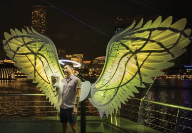 Person being photographed in a light installation in Singapore  Person being photographed in a light installation in Singapore as the Arts university a milestone for Singapore