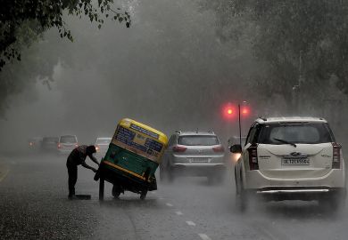 An Indian auto rickshaw driver tries to repair his vehicle after it broke down in heavy rain in New Delhi An Indian auto rickshaw driver tries to repair his vehicle after it broke down in heavy rain in New Delhi to illustrate Graduate unemployment emerges as Indian election issue