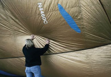 Person inflates hot air balloon Person inflates hot air balloon to illustrate Legal pressure from Free Speech Union forces Essex policy revisions