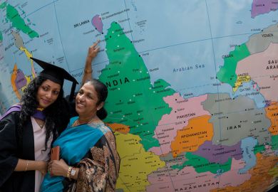 Graduate and lady pose for photograph infant of giant globe to illustrate Offer loans to turbocharge Indian recruitment, Johnson tells UK