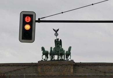 A traffic light with red and yellow signs is pictured in front of the Brandenburg Gate A traffic light with red and yellow signs is pictured in front of the Brandenburg Gate to illustrate New German government promises university funding boost