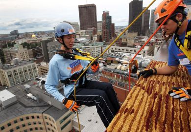 Person abseil on side of building with person watching to illustrate Trust-based bookkeeping could prompt timid partnering