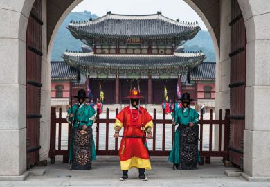 Guards of Gyeongbokgung Palace wearing face masks with traditional pattern stand at the gate of the palace Guards of Gyeongbokgung Palace wearing face masks with traditional pattern stand at the gate of the palace to illustrate Welcome foreigners to avoid demographic cliff edge, Korea told