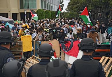 Pro-Palestinian demonstrators confront police as they clear an encampment after students occupied the Physical Sciences Lecture Hall at the University of Californi Pro-Palestinian demonstrators confront police as they clear an encampment after students occupied the Physical Sciences Lecture Hall at the University of California to illustrate Colleges ‘declare war’ on Gaza protest movement ahead of new year