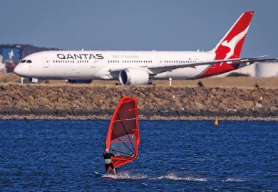 A sail boarder rides in front of a Qantas Airways plane A sail boarder rides in front of a Qantas Airways plane to illustrate New Colombo Plan changes ‘will reverse equity gains’