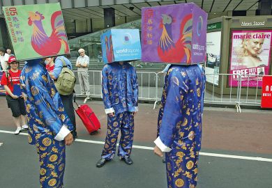 A group of performers cover their heads with boxes in Sydney, Australia to illustrate Excessive secrecy ‘undermining security’ of Australian research