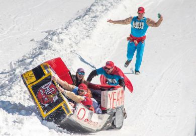 Participants react after sledding down the mountain and crashing their Duff Brothers themed sled  in Scranton, Pennsylvania, to illustrate NCAA bankruptcy would ‘reshape college sports landscape’