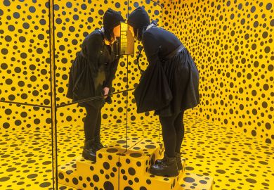 An immersive installation with a person looking into a mirror box in a bright yellow room overrun with black dots in Adelaide Australia An immersive installation with a person looking into a mirror box in a bright yellow room overrun with black dots in Adelaide Australia to illustrate Purge of lectures at Adelaide ‘breaches co-creation commitment’