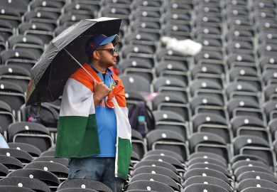 A fan shelters from the rain with an umbrella as play is delayed during the Semi-Final match of the ICC Cricket World Cup 2019 between India and New Zealand A fan shelters from the rain with an umbrella amongst empty seats as play is delayed during the Semi-Final match of the ICC Cricket World Cup 2019 between India and New Zealand to illustrate ‘Tough year’ for UK international student recruitment