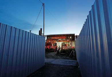 Metal fences from a construction site stand around Chao Mae Thap Thim shrine in Bangkok to illustrate Thai students document fight against ‘unjust’ shrine demolition