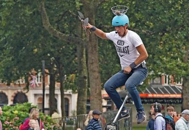 A juggling unicyclist dismounts from his cycle in Leicester Square in London to illustrate Role of HE in skills ‘crucial’