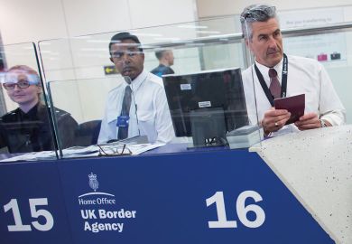 Border Force check the passports of passengers arriving at Gatwick Airport to illustrate Immigration check refusenik stripped of Keele fellowship