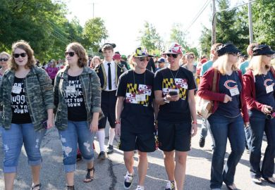 Twins walking together  Twins Day Festival in Twinsburg Ohio to illustrate Will ‘dual enrolment’ surge promote social equity