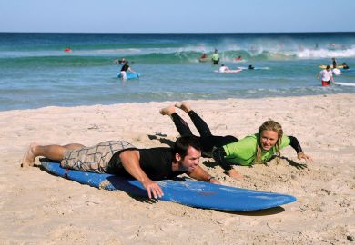 Person given a surfing lesson  Person given a surfing lesson to illustrate Tuition fee review ‘must go back to first principles’