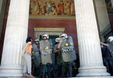 Police block the entrance to the central Athens university to illustrate Greeks fed up with anarchy on campuses 