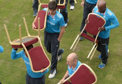 England  team carry back their chairs after a team photo.