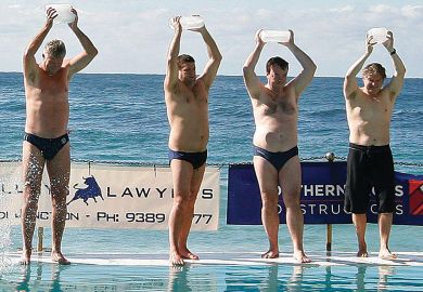 People carry ice blocks as they prepare to get into the pool next to the Pacific Ocean at Bondi Beach in Sydney.