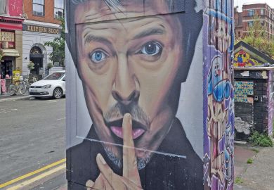 Wall Graffiti of a man with a finger to his lips at the Northern Quarter Art in Stevenson Square Manchester, UK to illustrate Students back employer levy to fund English higher education