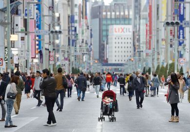 Baby alone in a pram in the city of Tokyo, Ginza to illustrate Japanese women with student loans more likely to delay child-rearing