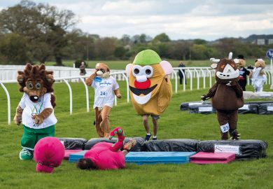 Runners dressed as mascots with a dinosaur fallen in front Western universities reflect on their role as ‘soft power’ Runners dressed as mascots with a dinosaur fallen in front to illustrate