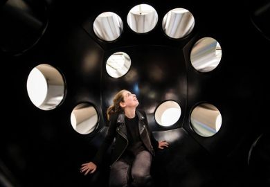 Woman sitting in an art installation looking at the holes Woman sitting in an art installation looking at the holes to illustrate don’t fear losing Elsevier access, California negotiator tells UK