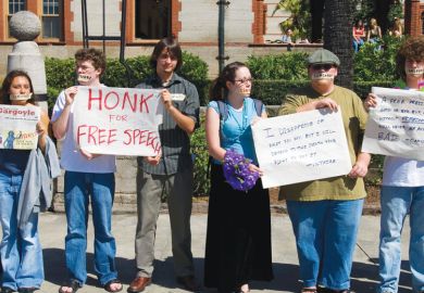 American students protest holding placards, one reads 'Honk for free speech'   American students protest to illustrate Florida retreats in voting rights case but free speech harm done