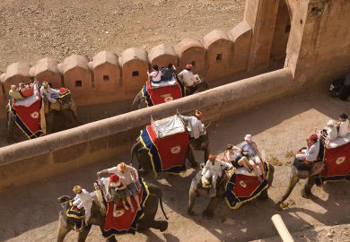 Tourists ride on elephants up to the Amber Fort, Jaipur, India.