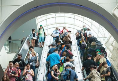  Crowds on escalator at the convention center in San Diego, California.