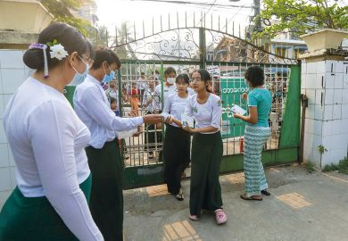 Students enter a high school for the matriculation exam as explained in the article