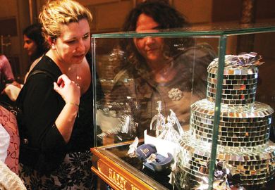 Two people look at a case of one of the world's largest diamonds in New York City as a metaphor for Biden’s $300 billion campaign promise met with scepticism.