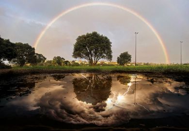 Montage: a rainbow is reflected in a puddle of water, in mono, in Auckland with lightning in the reflection to illustrate Without negative reviews, positive ones lose meaning