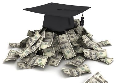 Mortar board with cash Mortar board with cash to illustrate Pressure to pass mediocre students made me leave academe