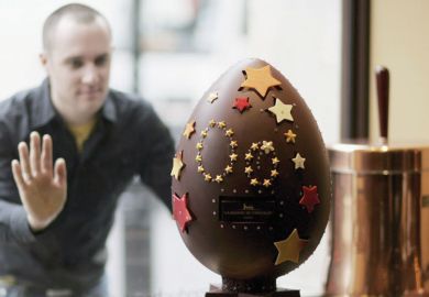 Man looking through window at the UK's most expensive diamond encrusted chocolate egg the world's finest chocolatier, unveils the UK's most expensive diamond encrusted chocolate egg as a metaphor for publishing paper in top journal costs about $1,000, says study