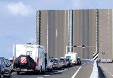 Cars are stopped by a draw-bridge on the A6 Highway near Swifterbant, Netherlands Cars are stopped by a draw-bridge on the A6 Highway near Swifterbant, Netherlands to illustrate Dutch universities unveil plan to limit international enrolments