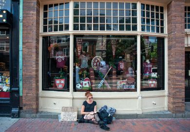 Young homeless girl sitting outside the Harvard University T-shirts books and souvenirs store in the city center Massachusetts Avenue, Cambridge, Massachusetts, USA Young homeless girl sitting outside the Harvard University T-shirts books and souvenirs store in the city center Massachusetts Avenue, Cambridge, Massachusetts, USA to illustrate edX architects tackle online access afresh with Axim