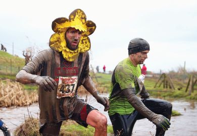 A competitor runs wearing a flower around his head covered in mud.jpg A competitor runs wearing a flower around his head covered in mud as a metaphor for UK ‘needs coherent plan’ for research spending after Horizon row.