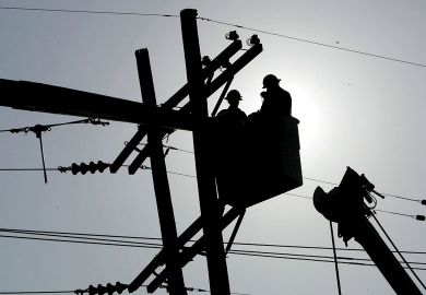 Utility workers repair a power line to show The 10-year programme aims to reshape America’s economy by spending big on transport projects, advanced manufacturing and clean energy.