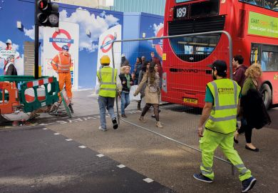 Workman carry a construction fence across Oxford Street in central London to illustrate Shift to relationship bans ‘signals new approach in universities’